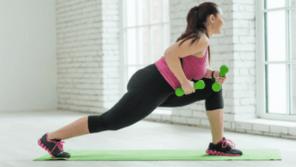 A garota faz um exercício com halteres